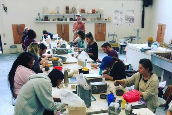 Art students working in the ceramics studio