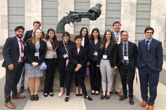 Model UN students in front of the knotted gun sculpture outside the UN General Assembly