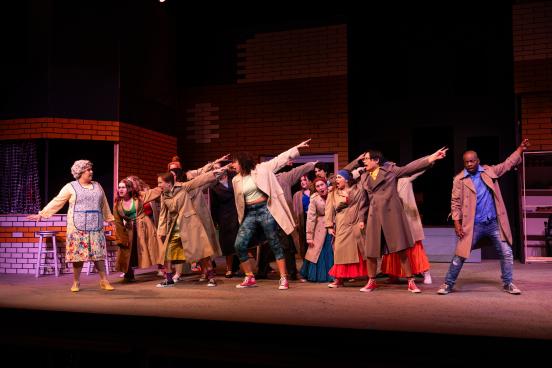 Students on stage in a theatre production