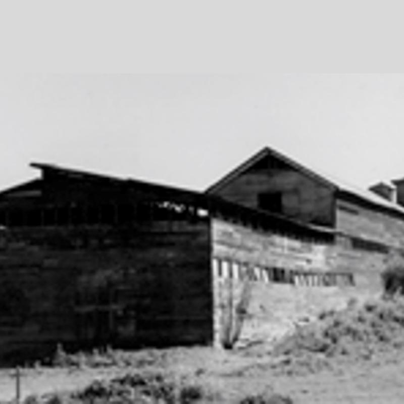 A black and white photo of an old barn