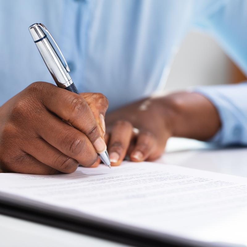 A person filling out a form