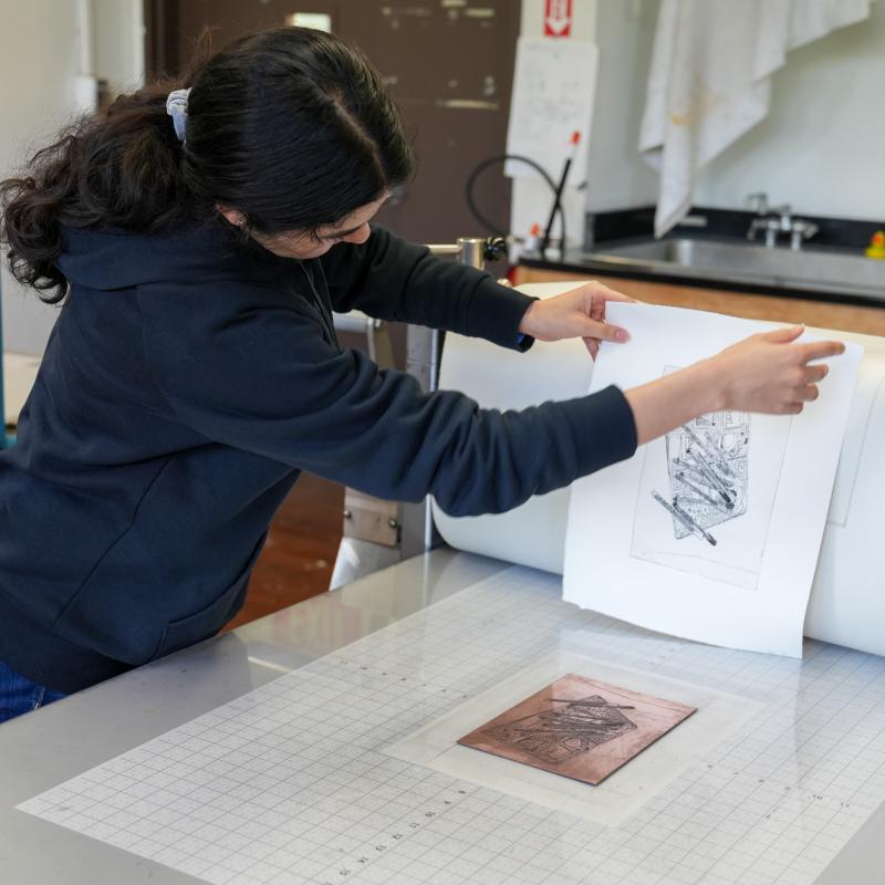 Student lifting paper to look at illustration
