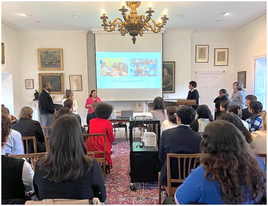 Students standing at the front of a room presenting to an audience