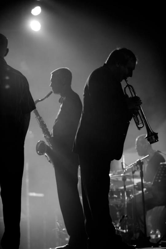 Silhouette of musicians playing saxophone and trumpet